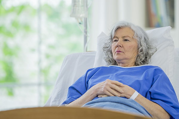 Senior woman in hospital bed.