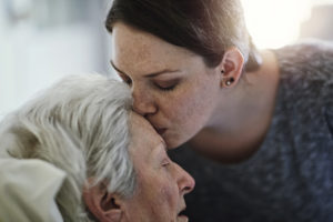 daughter visiting her senior mother in hospital