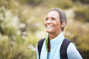 senior woman backpacking and exploring