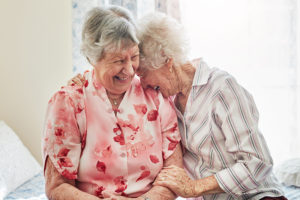 happy elderly women spending time with each other at home