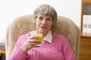 senior woman drinking orange juice