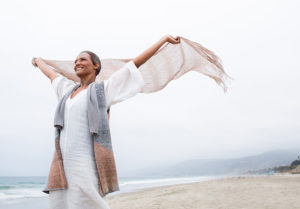 happy woman on beach in the wind