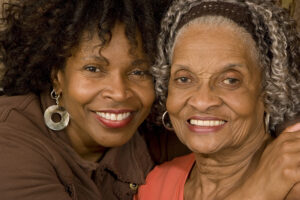 adult dementia caregiver with happy senior mother