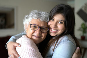 senior hugging family caregiver