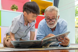 grandchild-and-grandpa-reading-book