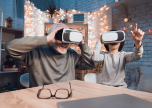 Senior man using virtual reality headset with grandchild