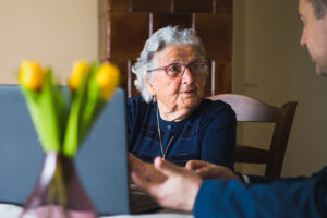 Caregiver explaining the cost of care to senior woman