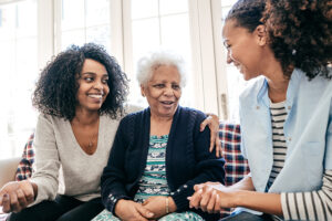 daughter and senior mother talking to caregiver