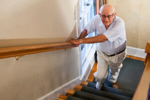 Happy senior man walking up the stairs