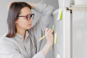 Family caregiver writing post it notes