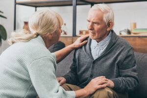 Senior woman comforting concerned senior man