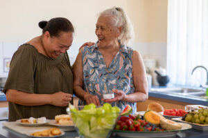 Happy senior women preparing food together