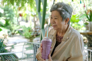 Senior woman drinking a smoothie