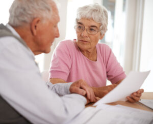 Senior couple discussing the cost of home care for veterans