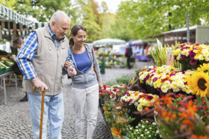 caregiver with senior shopping for flowers