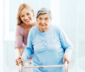 Caregiver helping senior with a walker