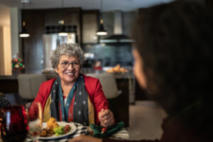 A family is discussing the health of aging parents as they enjoy a holiday meal together.