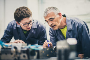 A young adult get advice from an older gentleman through senior mentoring. 